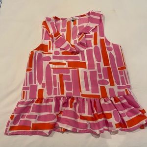 Michelle McDowell sleeveless blouse with ruffle hem